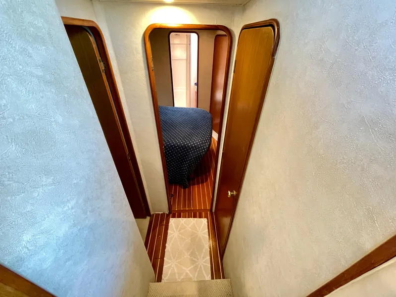 Slide: The Image of Interior hallway of 2000 Ocean Yachts 43 Super Sport, featuring wood accents and cozy cabin. - 8