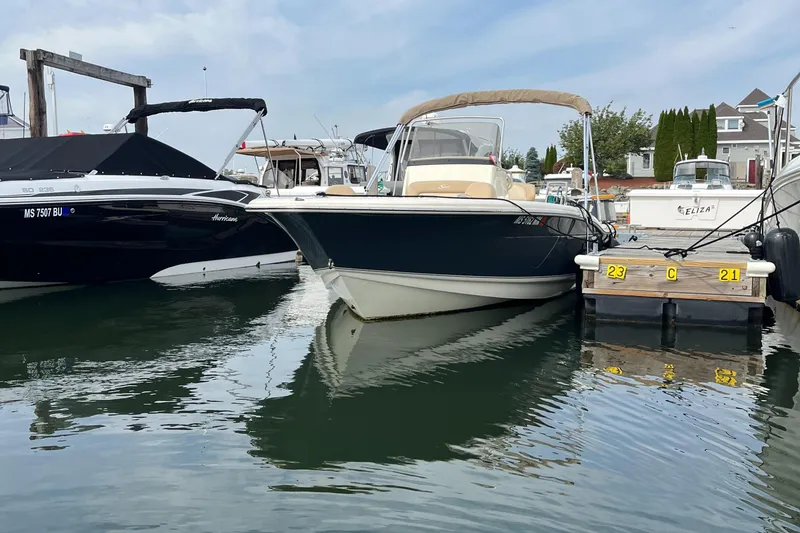 Slide: The Image of 2024 Scout 195 Sportfish boat docked at marina. - 1