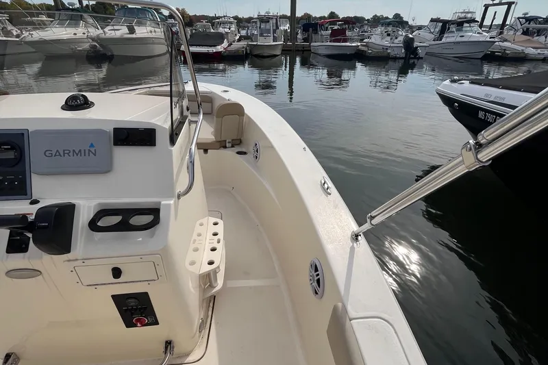 Slide: The Image of 2024 Scout 195 Sportfish boat docked, featuring Garmin navigation system. - 10