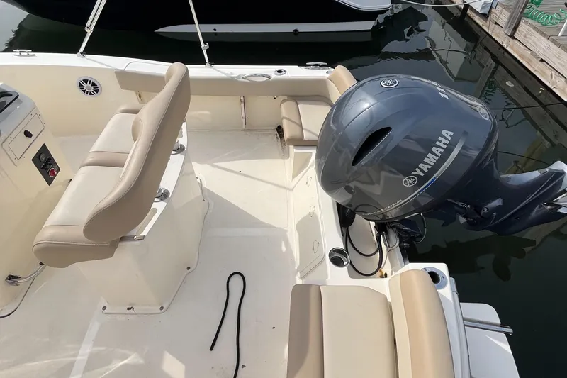 Slide: The Image of 2024 Scout 195 Sportfish boat with Yamaha outboard engine, docked at marina. - 13