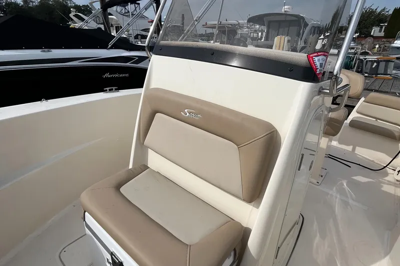 Slide: The Image of 2024 Scout 195 Sportfish boat interior with beige seating and console. - 14