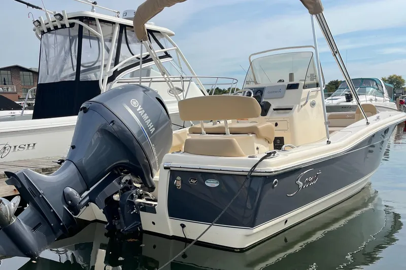 Slide: The Image of 2024 Scout 195 Sportfish boat with Yamaha outboard engine docked in marina. - 3