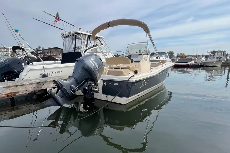 Slide: The Image of 2024 Scout 195 Sportfish boat docked in marina, featuring Yamaha outboard motor. - 4