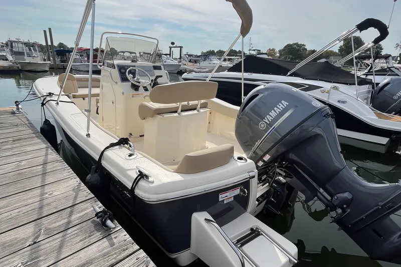 Slide: The Image of 2024 Scout 195 Sportfish boat docked with Yamaha outboard motor. - 5