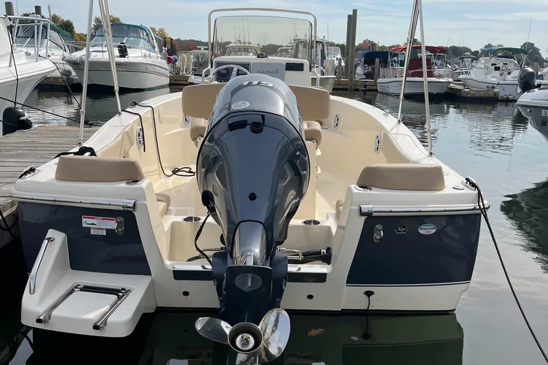 Slide: The Image of 2024 Scout 195 Sportfish boat docked at marina, rear view. - 6