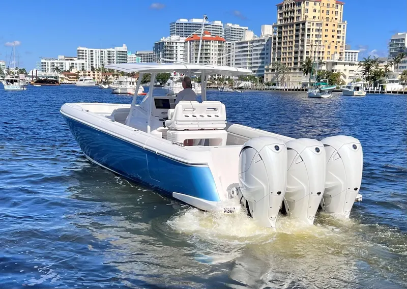 Slide: The Image of 2021 Intrepid 407 Nomad FE boat cruising in a city harbor. - 15