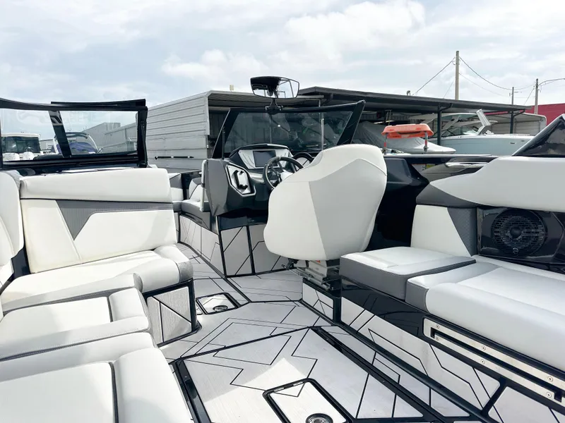 Slide: The Image of 2024 Supreme S240 boat interior with modern seating and sleek dashboard design. - 8