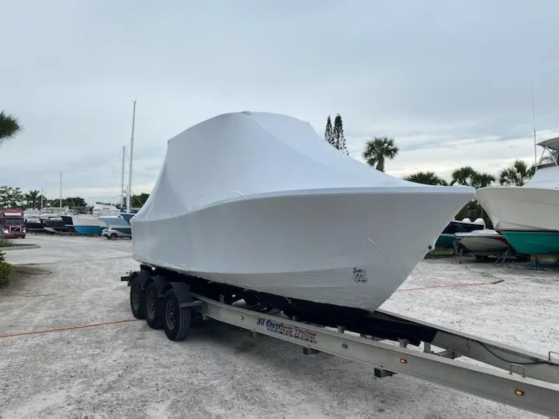 Slide: The Image of 2017 Regulator 23 Forward Seating boat covered on trailer in outdoor storage area. - 11