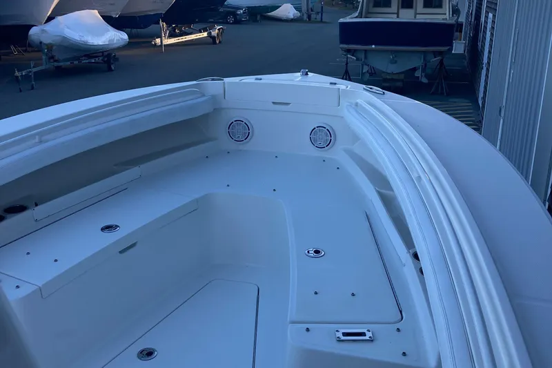 Slide: The Image of 2020 Regulator 23 Forward Seating boat, spacious deck view, docked in marina. - 14