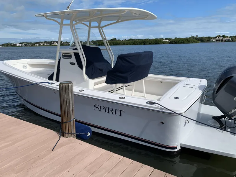 Slide: The Image of 2017 Regulator 23 Forward Seating boat docked by a serene lake. - 3