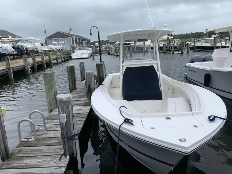 Slide: The Image of 2017 Regulator 23 Forward Seating boat docked at a marina under cloudy skies. - 5