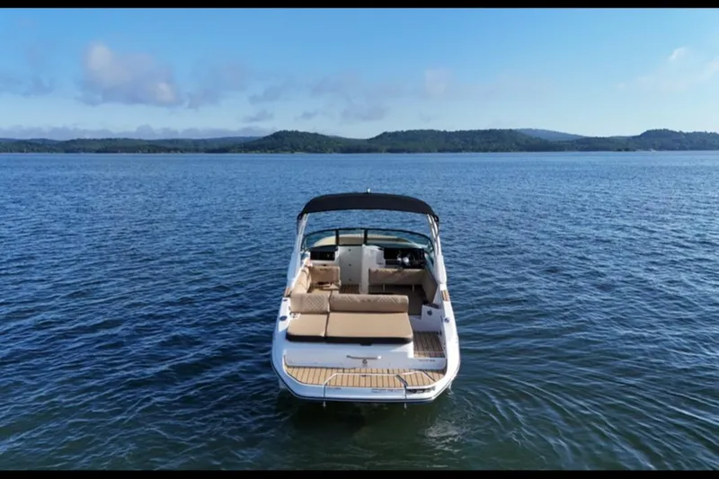 Slide: The Image of 2025 Sea Ray SDX 270 boat on calm lake with scenic mountain backdrop. - 11