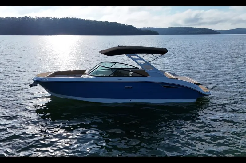 Slide: The Image of 2025 Sea Ray SDX 270 boat on a serene lake with scenic background. - 15
