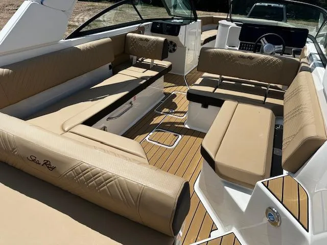 Slide: The Image of 2025 Sea Ray SDX 270 boat interior with tan seating and wood flooring. - 3