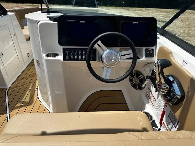 Slide: The Image of 2025 Sea Ray SDX 270 helm with modern controls and beige seating. - 5