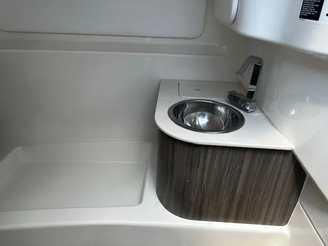 Slide: The Image of 2025 Sea Ray SDX 270 boat interior sink and faucet detail. - 8