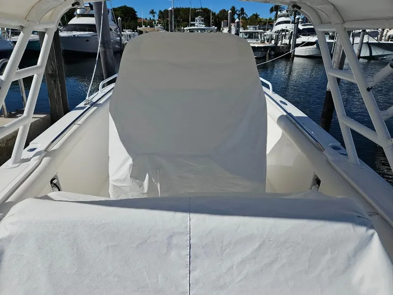 Slide: The Image of 2004 Marlago FS35 boat interior with covered seating at marina. - 10