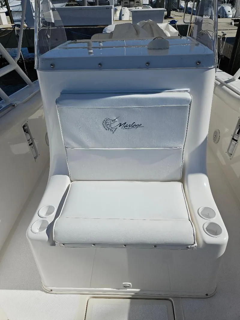 Slide: The Image of 2004 Marlago FS35 boat seat with logo, featuring cup holders. - 12