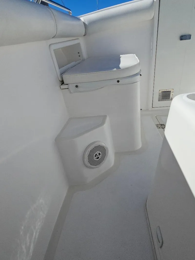 Slide: The Image of 2004 Marlago FS35 boat interior with seating and speaker. - 14