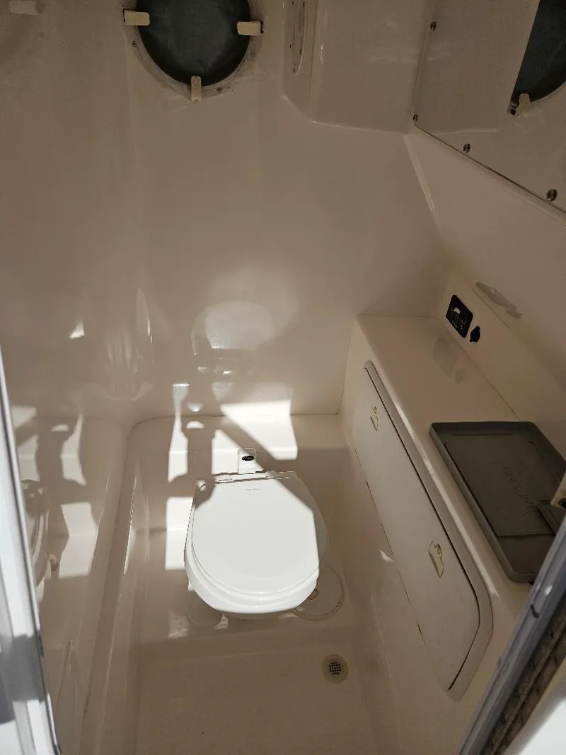 Slide: The Image of 2004 Marlago FS35 boat interior bathroom with toilet and sink. - 17