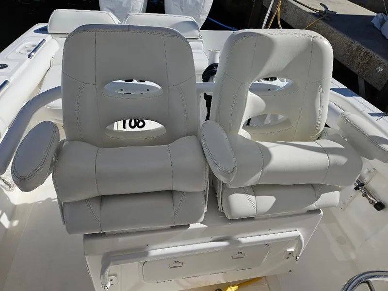 Slide: The Image of 2004 Marlago FS35 boat with white cushioned seats in cockpit area. - 19