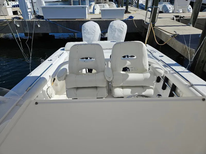 Slide: The Image of 2004 Marlago FS35 boat with white seating at a dock. - 20