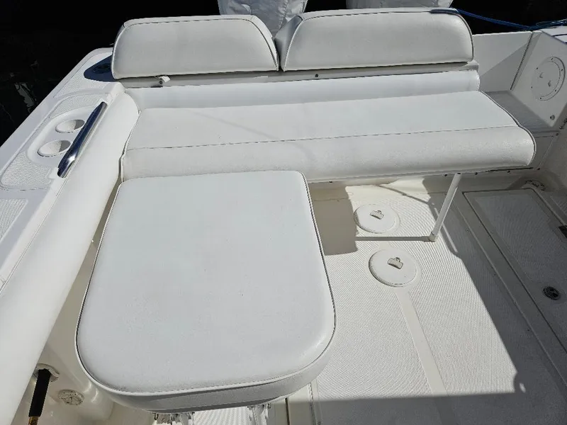 Slide: The Image of 2004 Marlago FS35 boat interior with white cushioned seating. - 21