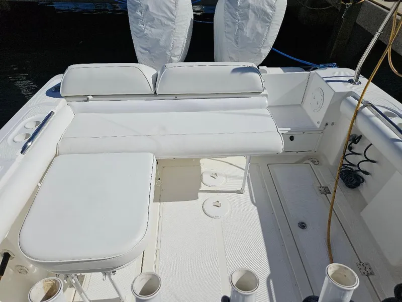 Slide: The Image of 2004 Marlago FS35 boat interior with white seating and deck. - 22