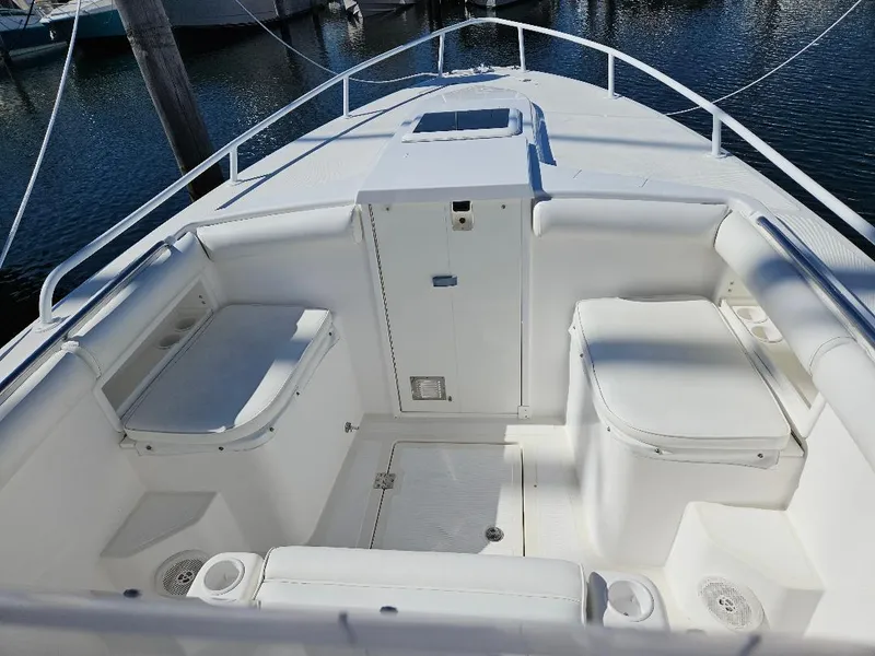 Slide: The Image of 2004 Marlago FS35 boat interior with white seating and storage compartments. - 23