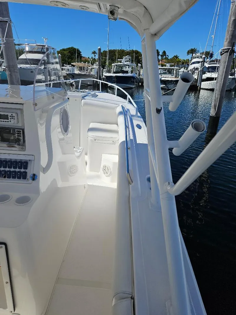 Slide: The Image of 2004 Marlago FS35 boat interior with rod holders, docked in a marina. - 26