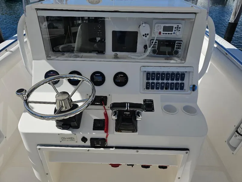 Slide: The Image of 2004 Marlago FS35 boat dashboard with steering wheel and control panel. - 28
