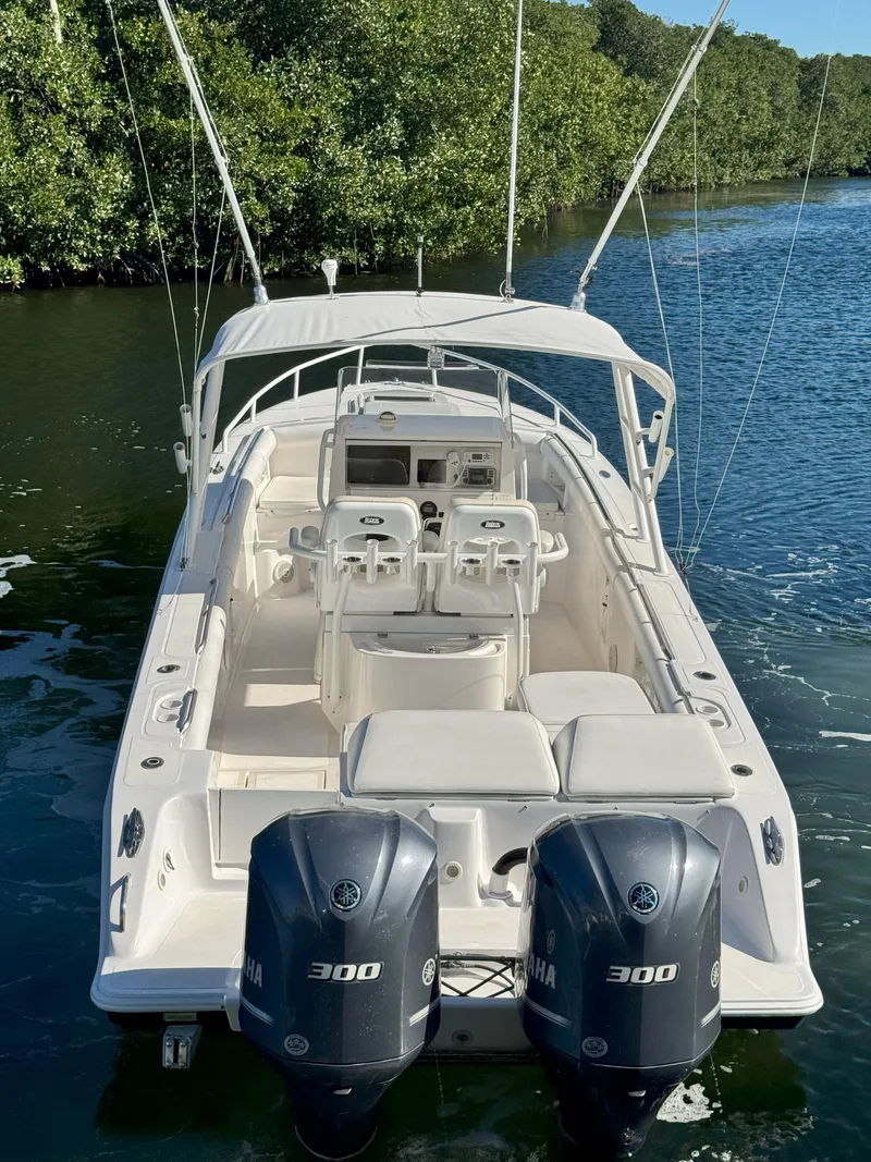 Slide: The Image of 2004 Marlago FS35 boat with dual Yamaha 300 engines on a serene waterway. - 3