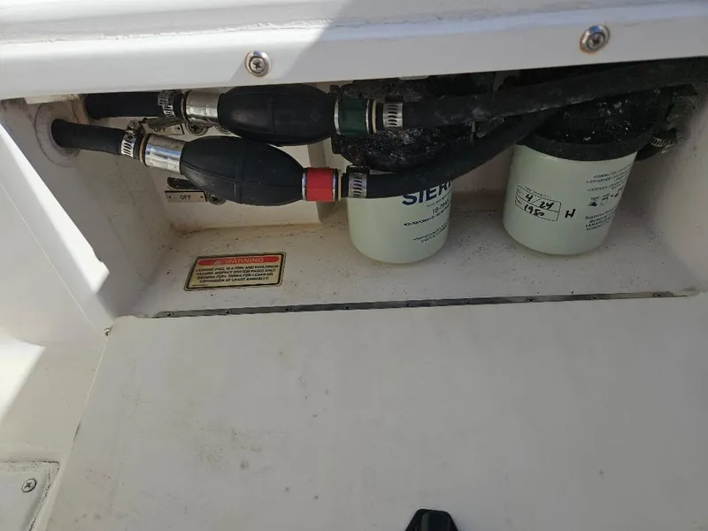Slide: The Image of 2004 Marlago FS35 boat engine compartment with fuel filters and hoses. - 36