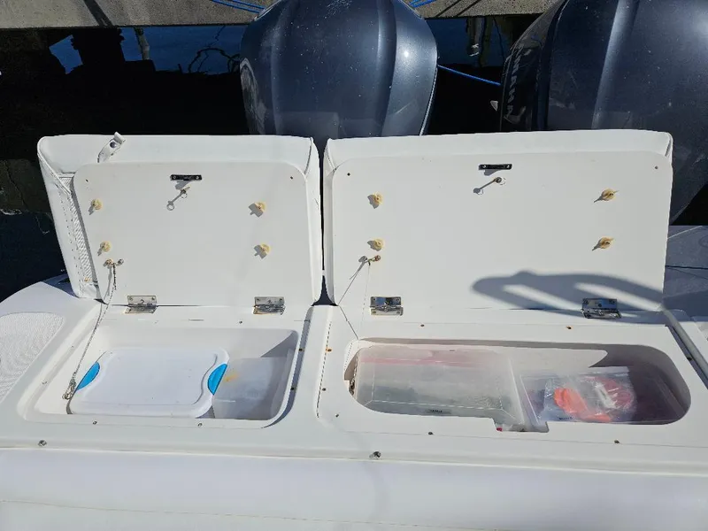 Slide: The Image of Open storage compartments on a 2004 Marlago FS35 boat, showing organized gear and equipment. - 37