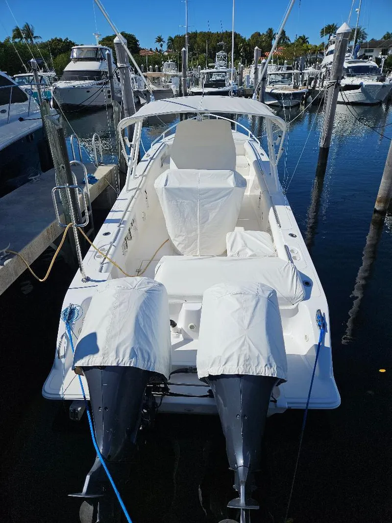 Slide: The Image of 2004 Marlago FS35 boat docked in marina, covered engines, clear blue sky. - 4