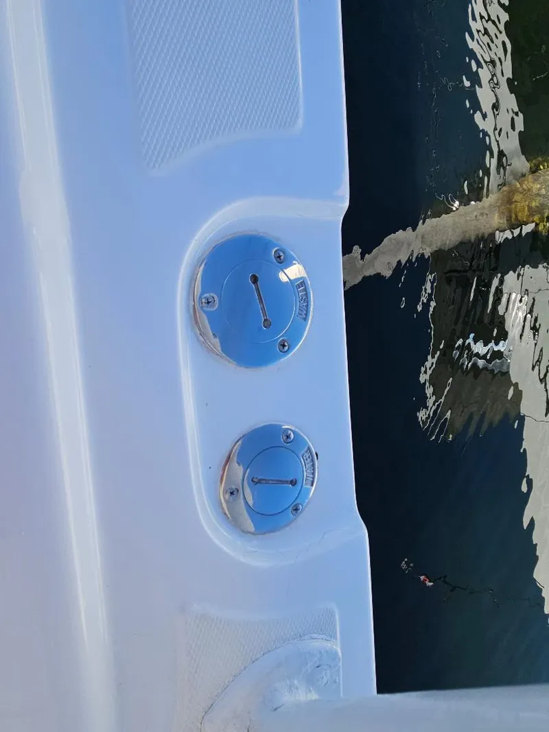 Slide: The Image of 2004 Marlago FS35 boat fuel and water caps by the water. - 41