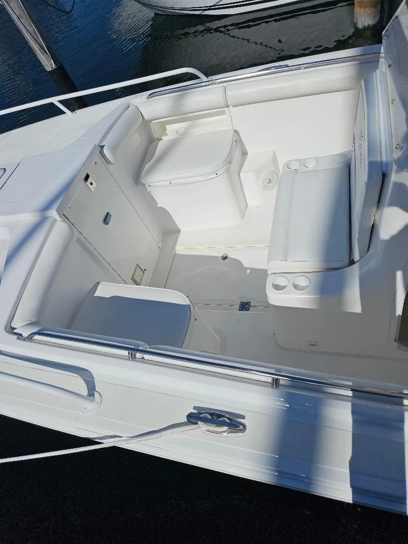 Slide: The Image of 2004 Marlago FS35 boat interior with white seating and storage compartments. - 42