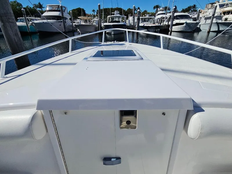 Slide: The Image of 2004 Marlago FS35 boat docked in a marina, surrounded by other vessels. - 7
