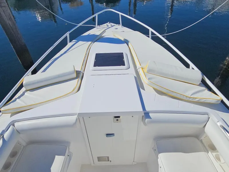 Slide: The Image of 2004 Marlago FS35 boat deck with cushioned seating and clear blue water. - 8