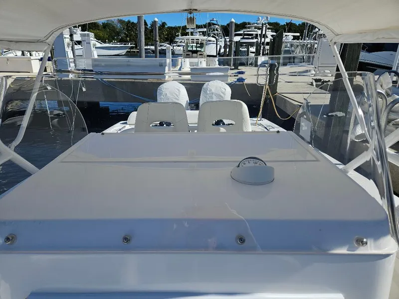 Slide: The Image of 2004 Marlago FS35 boat interior at a marina, featuring white seating and dashboard. - 9