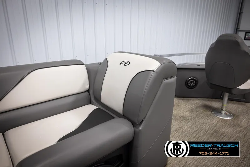 Slide: The Image of 2024 Avalon VEN QF boat interior with gray and white seating, Reeder-Trausch Marine logo. - 22