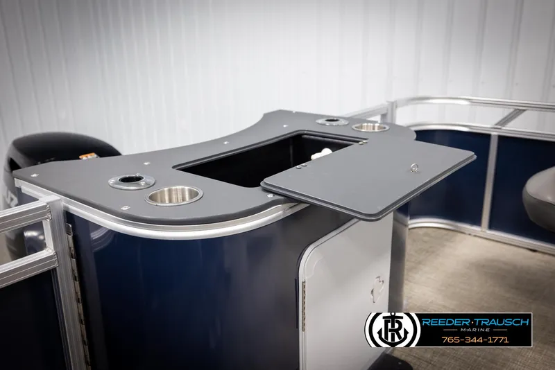 Slide: The Image of 2024 Avalon VEN QF boat interior with open storage compartment and cup holders. - 25