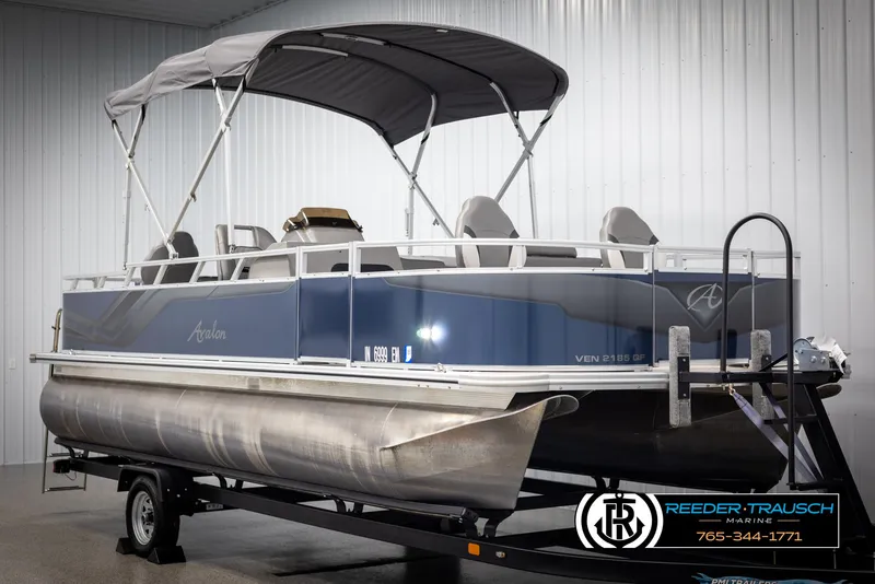 Slide: The Image of 2024 Avalon VEN QF pontoon boat with canopy on trailer in showroom. - 3