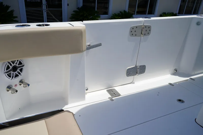 Slide: The Image of 2025 Edgewater 340CC boat seat with beige cushion and white panel, featuring dual engines. - 14