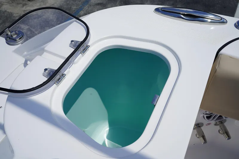 Slide: The Image of 2025 Edgewater 340CC boat deck with storage compartments and shadow. - 16
