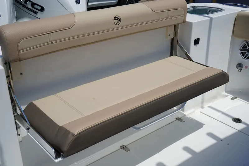Slide: The Image of 2025 Edgewater 340CC boat interior with cushioned seating and stainless steel rod holders. - 18