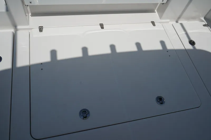 Slide: The Image of Edgewater 340CC 2025 boat interior with sleek white panels and metal fixtures. - 19