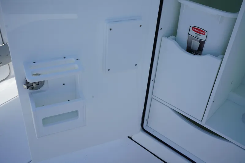 Slide: The Image of 2025 Edgewater 340CC boat interior with sink and storage area. - 26
