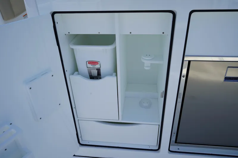 Slide: The Image of 2025 Edgewater 340CC boat sink with chrome faucet and white countertop. - 27