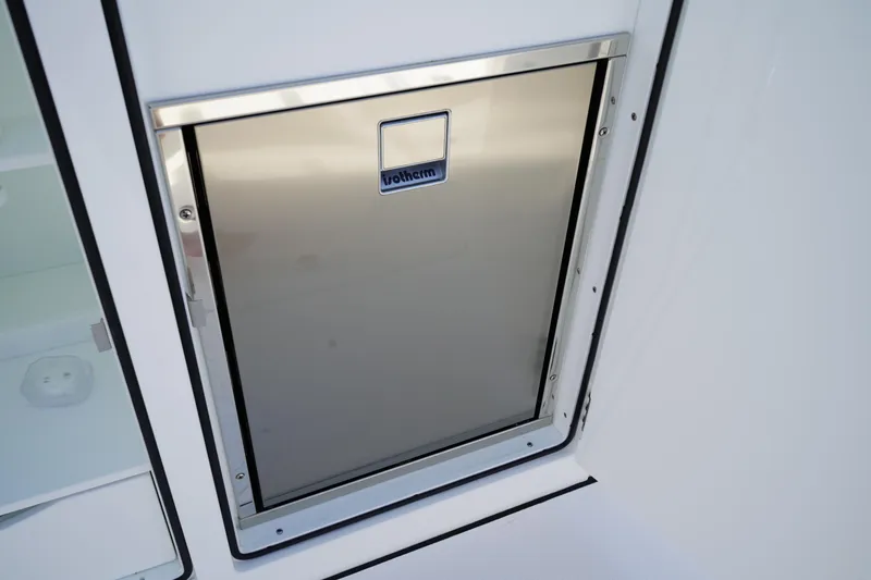 Slide: The Image of 2025 Edgewater 340CC boat with a sleek white countertop and stainless steel handle. - 28